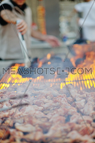 Barbecue with chicken  on grill, fire and smoke in background