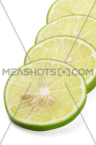 green fresh lime slices isolated over white background