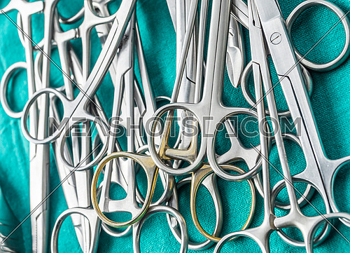 Scissors surgical in an operating theater, composition horizontal, conceptual image