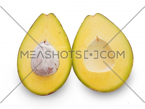 A fresh avocado cut in half on an isolated background
