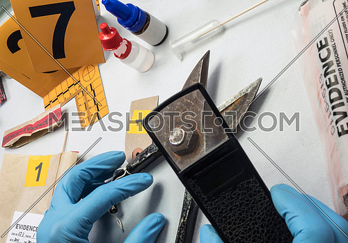 Police expert analyzes with magnifying glass some old grapple of the crime scene, conceptual image
