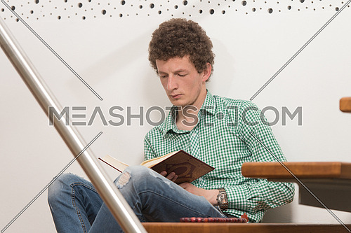 White Muslim Man Is Reading The Koran In The Mosque - Afro Lock Hair Curly