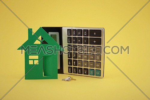 Property concept. Home loan, reverse mortgage, housing, business and finance. House and and calculator on yellow background and free copy space