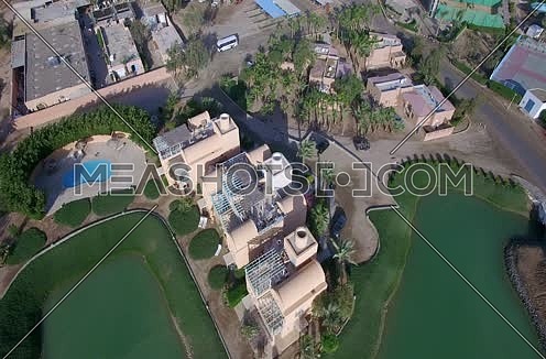 Drone shot flying above a House and a golf course Al Gouna at Day 