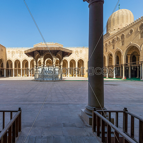 Ablution fountain mediating the courtyard of public historic mosque of Sultan al Muayyad, with background of arched corridors surrounding the courtyard, Cairo, Egypt