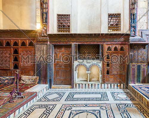 Wooden painted floral patterns, embedded arched niche, wooden door, wooden engraved cupboard, calligraphy decoration, and marble floor with geometric pattern at El Sehemy ottoman era historic house