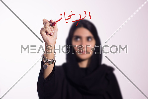 Arabian middle eastern business woman writing with a marker on virtual screen in arabic Achievement 
isolated on white background