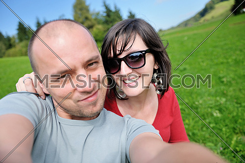 young happy couple have fun outdoor in nature