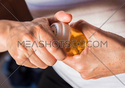 Woman opening pill jar in her hands, conceptual image
