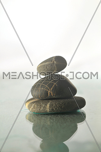 isolated wet zen stones with splashing  water drops  representing concept of natural balance and perfect harmony