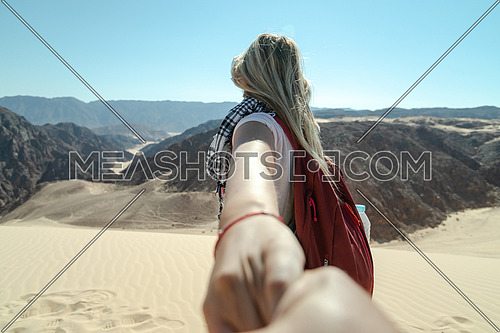 Follow me shot with blond female tourist in Ain Hodouda in sinai by day
