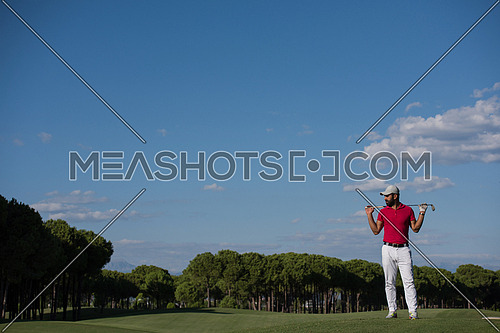 handsome middle eastern golf player portrait at course at sunny day wearing red  shirt