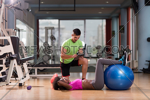healthy young couple exercise in gym pilates  workout with personal trainer