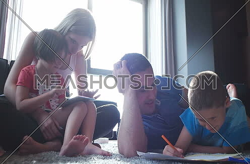 Familly lying on floot and having great time together