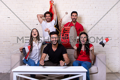 Group of people watching TV supporting the Egyptian Team