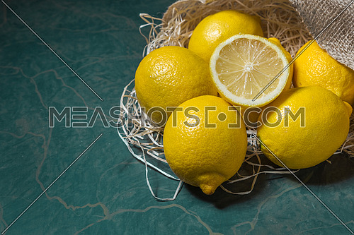 Fresh lemons stacked on jute sack