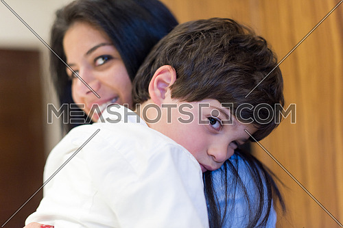 sleepy child on mother shoulder