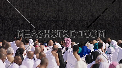 Close up (Slow-Motion) for Mulsim pilgrims during Tawaf around Kaaba.