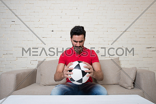 football fan watching a game with a ball