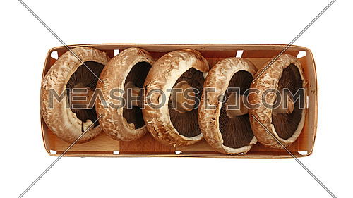 Close up one wooden crate box of fresh brown portobello mushrooms isolated on white background, elevated top view, directly above
