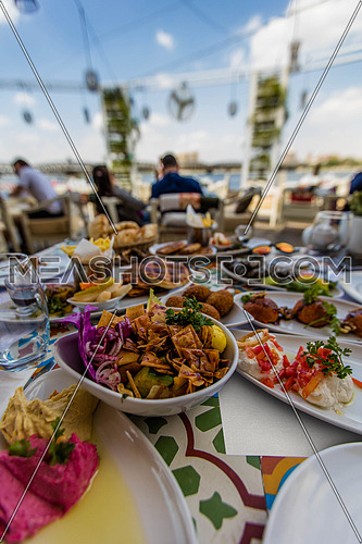 middle eastern food on a table in an outdoor restaurant