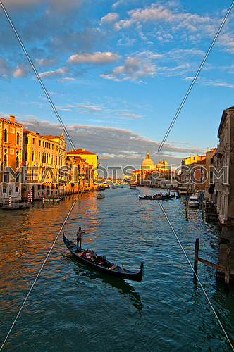 Venice Italy grand canal view from the top of Accademia bridge with "Madonna della Salute" church on background at sunset