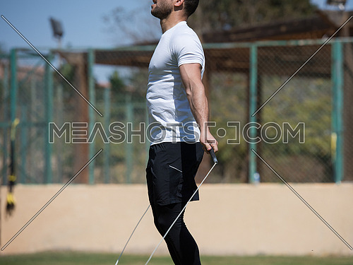 young middle eastern athlete man exercise skipping rope outdoors