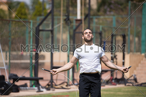 young middle eastern athlete man exercise skipping rope outdoors