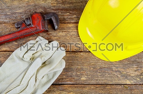 Building helmet tool safety gloves wrench construction safety equipment background.