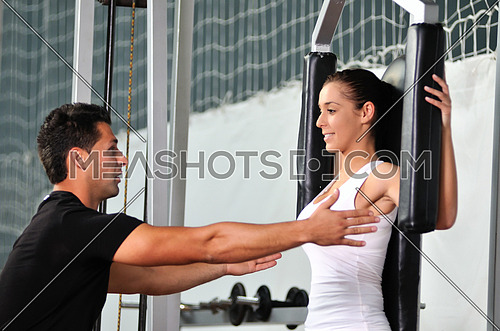 woman in the fitness gim working out with personal trainer coach