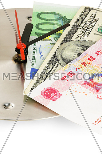 currency bills on a stainless steel clock clock on white back ground
