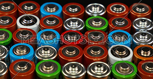 Close up background of assorted colorful electric alkaline batteries