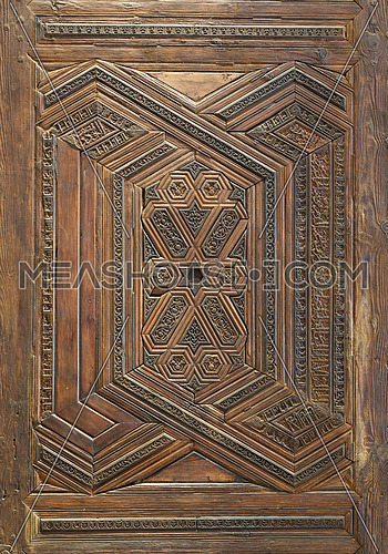 Geometrical and floral engraved patterns of Mamluk style wooden ornate door leaf of Madrasa of Sultan Nagm al Din Ayyub, Cairo, Egypt