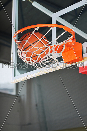 oreange basket ball in basketball basket