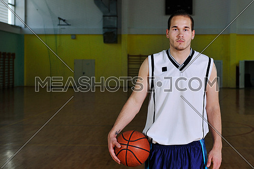 one healthy young  man play basketball game in school gym indoor relax