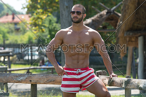 Smiling Athlete With Naked Torso Resting Outdoors