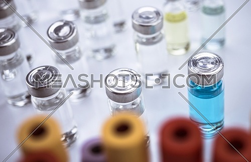 Medication vials along with blood samples in a hospital, conceptual image