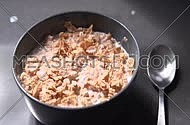 Pouring cereal flakes and milk