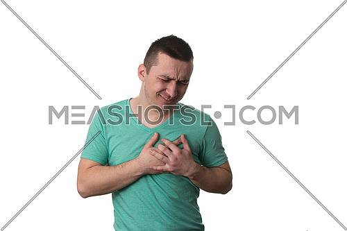 Young Man Holding A Hand To His Heart Due To This Pain - Over White Background Isolated