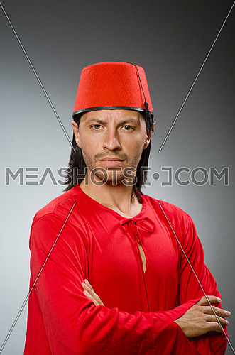 Funny man in red dress wearing fez hat