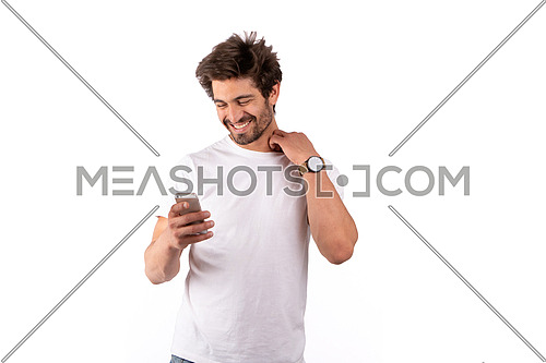 an Egyptian man holding a mobile phone dressed in white shirt and jeans