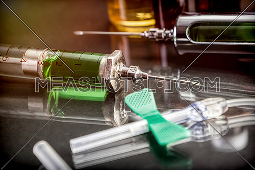 Some Vials And Syringe On Operating Table