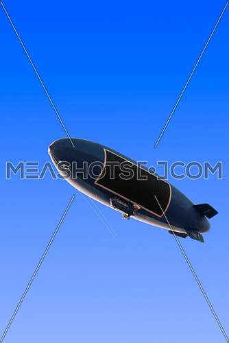 dirigible airship zeppelin over clean blue sky background