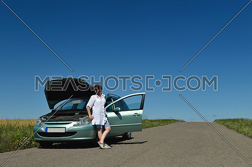 portrait of young beautiful woman with broken car outdoor