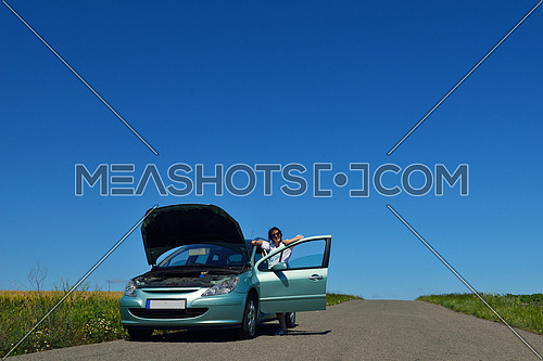 portrait of young beautiful woman with broken car