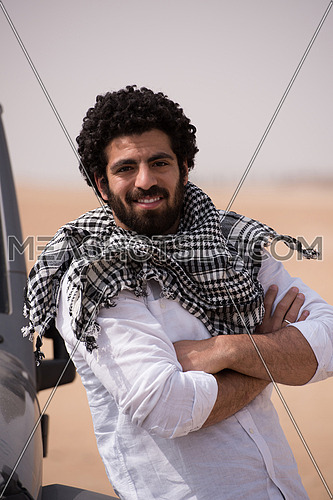 portrait of handsome middle eastern man in egyptian  desert