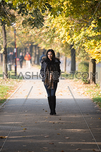 Young Woman Walking In Forest Through The Woods Outside During Autumn