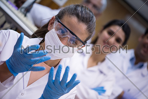 Young middle eastern woman enjoys working in a large modern laboratories