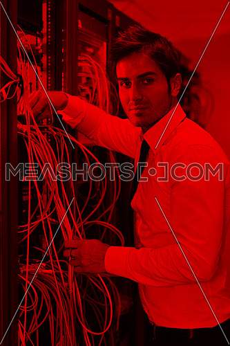 young handsome business man  engeneer in datacenter server room