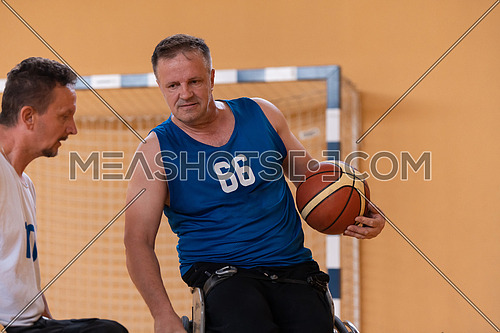 a photo of a war veteran playing basketball with a team in a modern sports arena. The concept of sport for people with disabilities. High quality photo